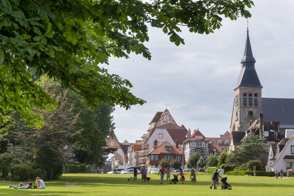 Le touquet with gardens and church and village green with people in front