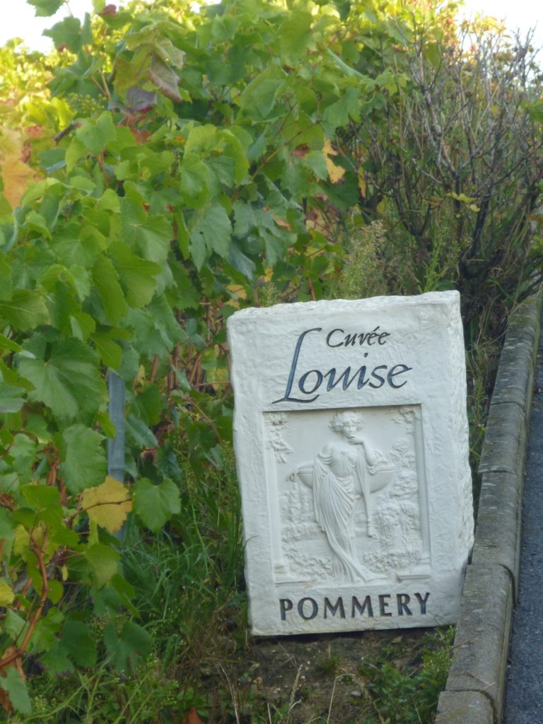 Stone with name Cuvee Pommery and picture of lady carved on a stone in Pommery vineyard