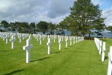 White gravestones above blue sea at Normandy American Cemetery, Colville-sur-Mer