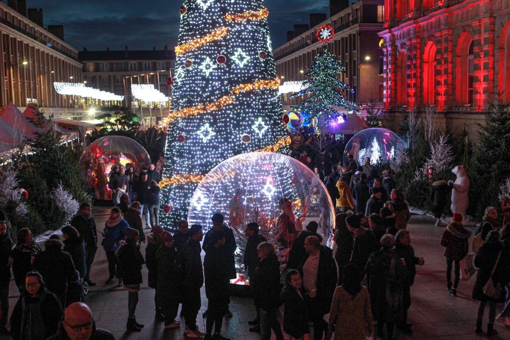 Huge semi open Christmas tree bauble with people inside in amiens
