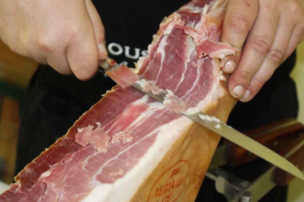 Hand slicing a ham 