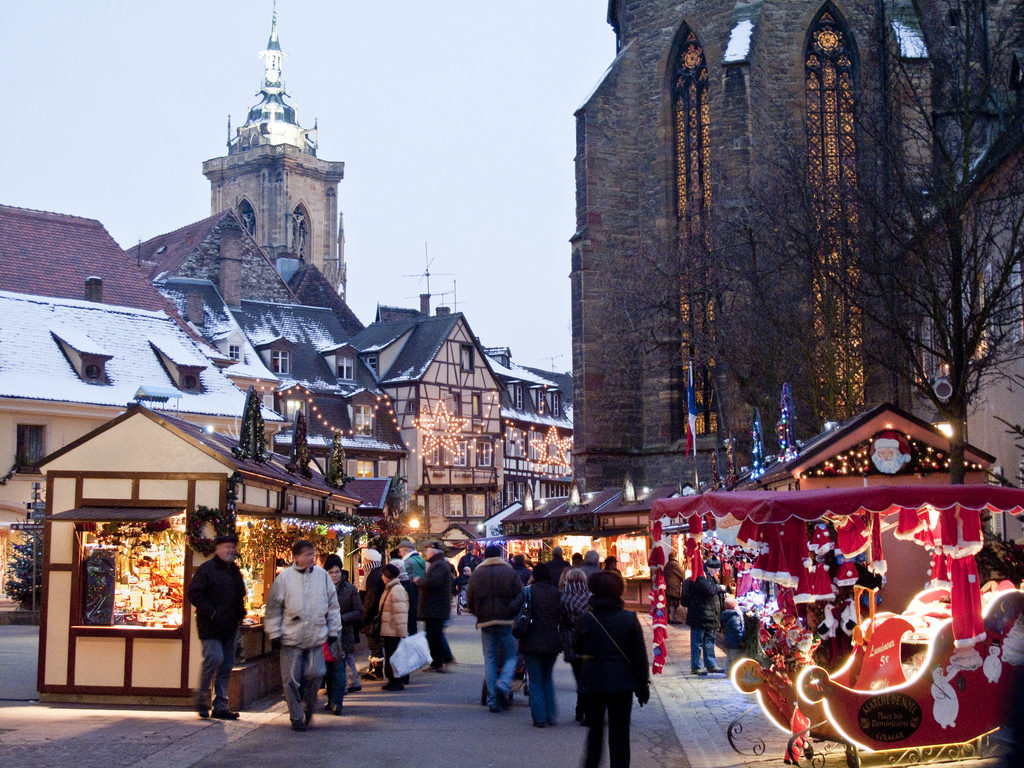 Colmar christmas Market with lit stalls and snowy rooves