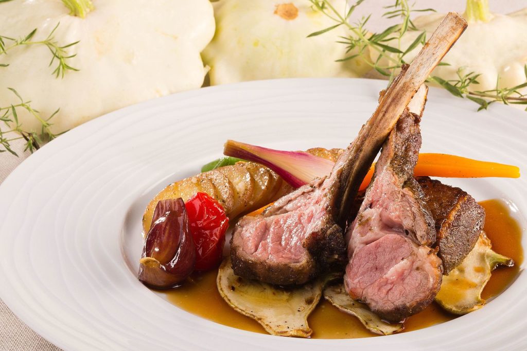 Tender Sisteron lamb chops on a plate with summer vegetables