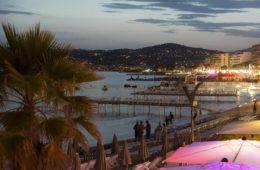 Juan les Pins at night with lit up bars in foreground and sea at back