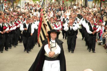 Procession of men with bagpipes in the street at Lorient Interceltic festival