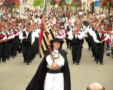 Procession of men with bagpipes in the street at Lorient Interceltic festival