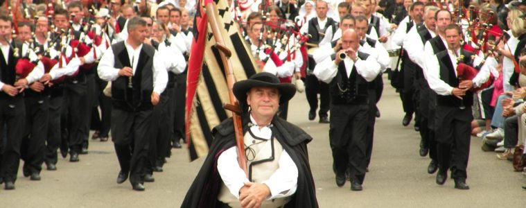 Procession of men with bagpipes in the street at Lorient Interceltic festival