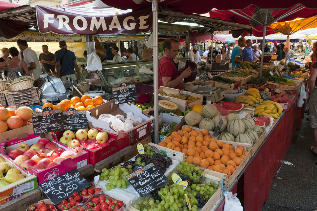 Aix-en-Provence market with stalls of fruit and vegetables and stall holder