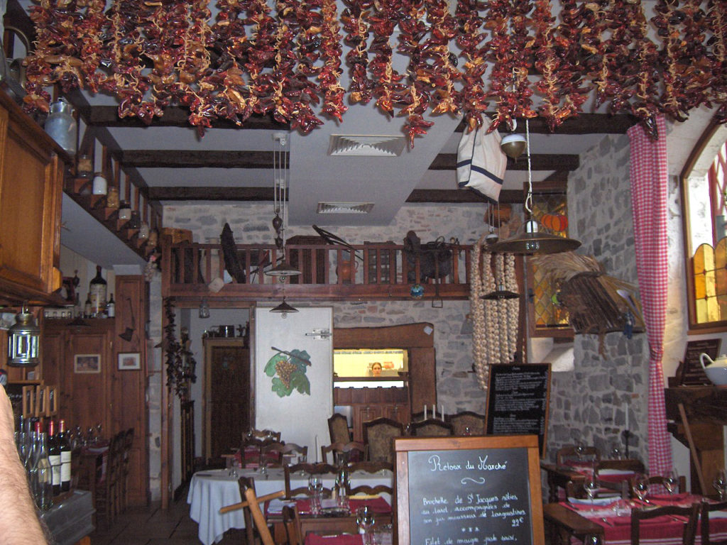 peppers hanging from a ceiling drying in bistro style restaurant in Bayonne