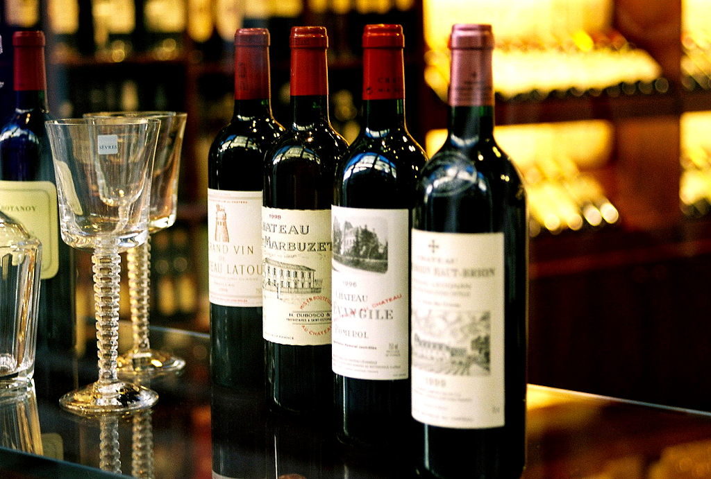 Bottles of top Bordeaux wines with 2 glasses