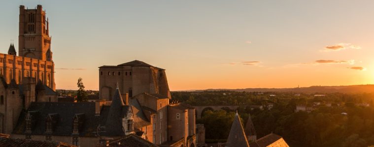 Albi in twilight with cathedral and museum to left all in golden sunset