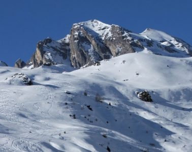 Pyrenees under show with sgentle slopes in foreground and mountains with snow in background
