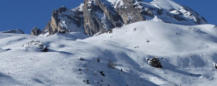 Pyrenees under show with sgentle slopes in foreground and mountains with snow in background