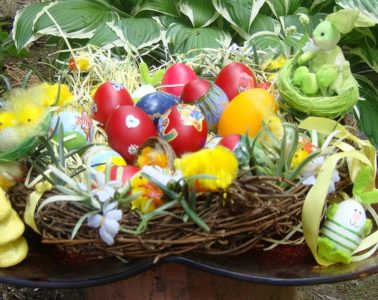 Very colourful Easter eggs with pretty twigs and leaves around