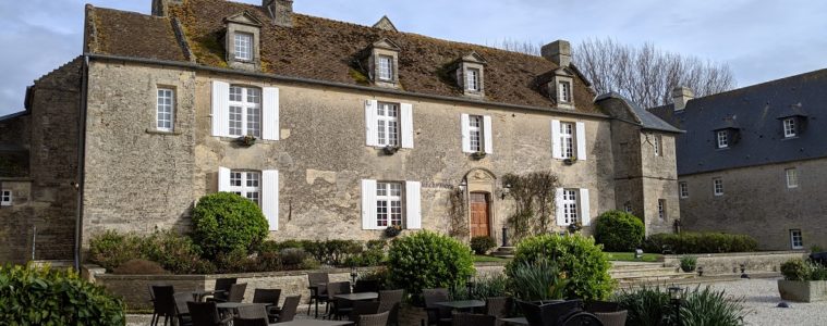 Large manor house exterior in grey stone at the Ferme de la Rançonnière