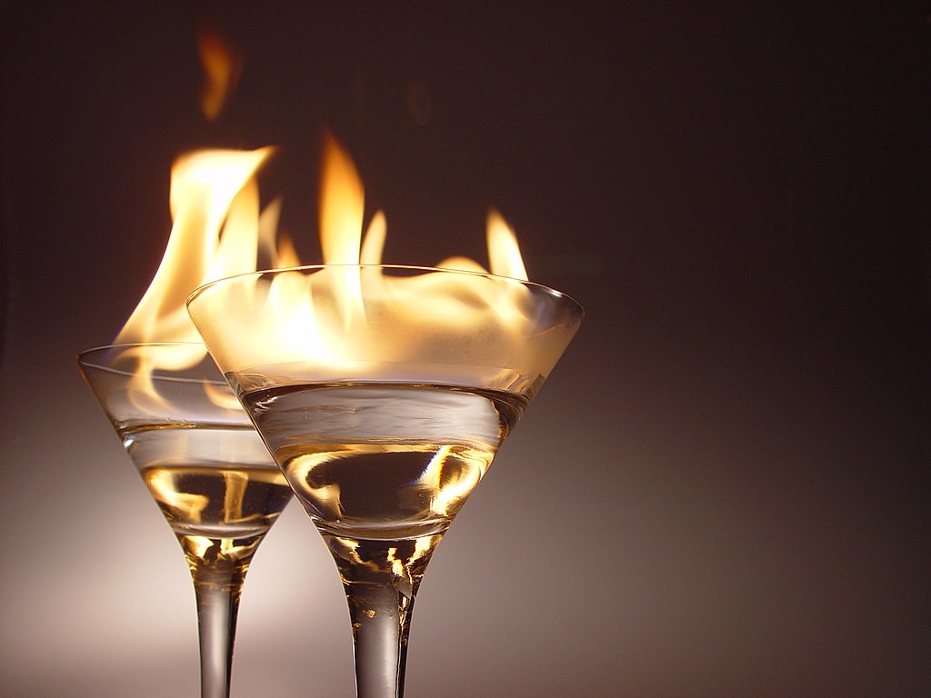 Two glasses of flaming cocktails