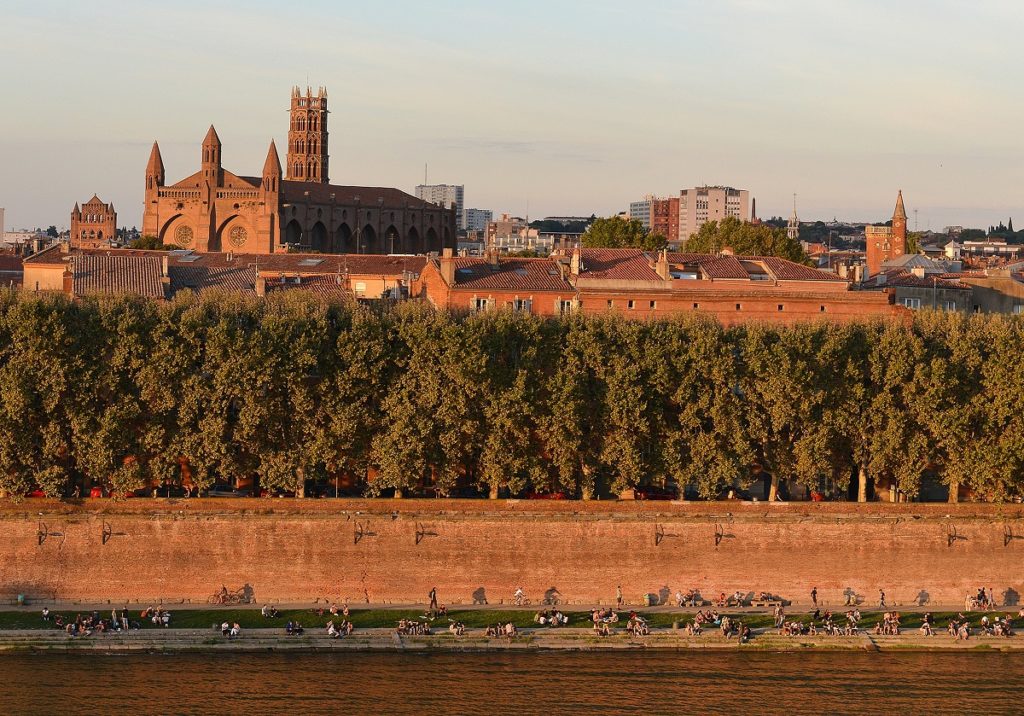 Garonne river at Toulouse with river in foreground and the red building of Toulouse behind
