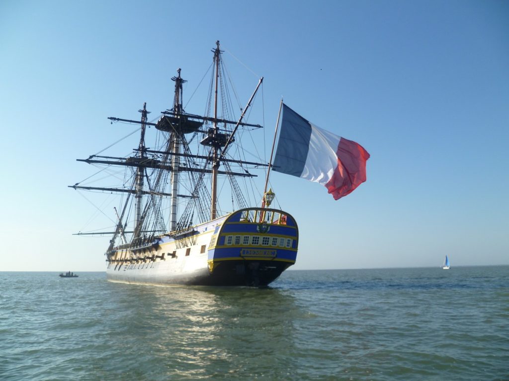 L'Hermione, the replica of the ship Lafayette took to America. At sea sailing away with French flag flying but no sails up