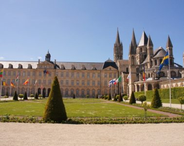 Abbaye aux Hommes stone building with lawn in front in Caen