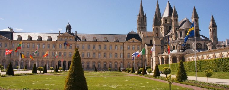 Abbaye aux Hommes stone building with lawn in front in Caen