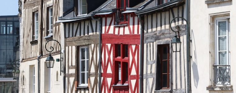 Renaissance houses in Orleans. Facade of three coloured, two grey on side of red half timbered houses