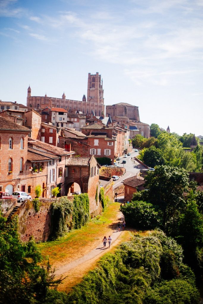 Albi from the river with red buildings and cathedral in b ackground