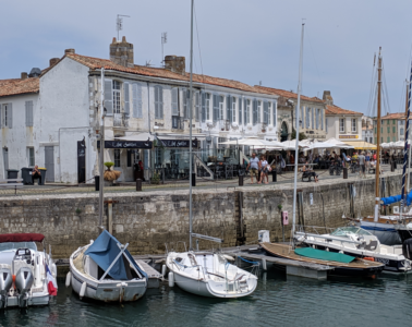 View over harbour with little boats in the water and whitewashed houses behind