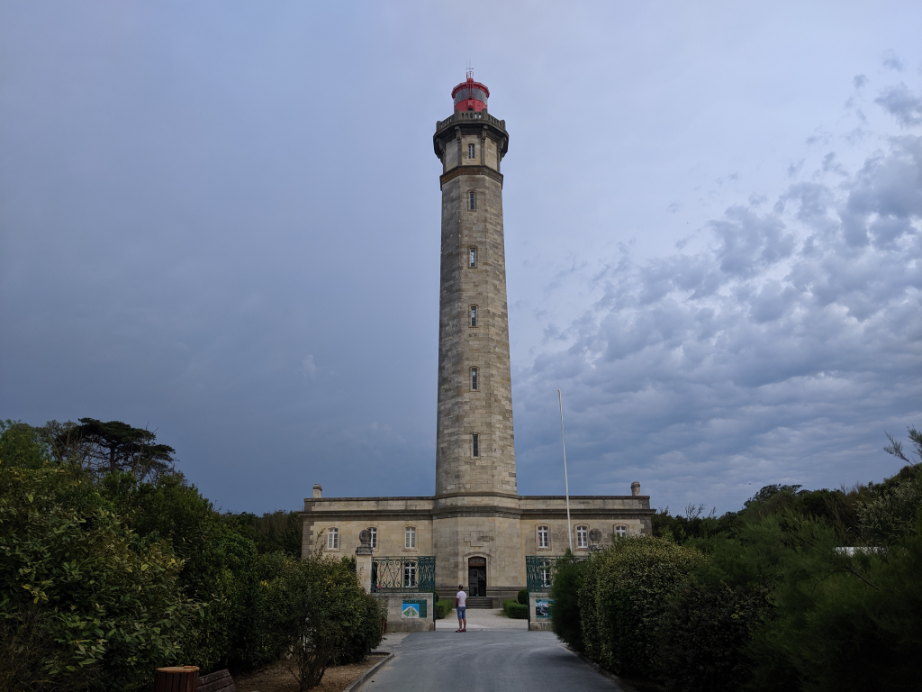 Ile de Re lighthouse with long low building and tall tower 