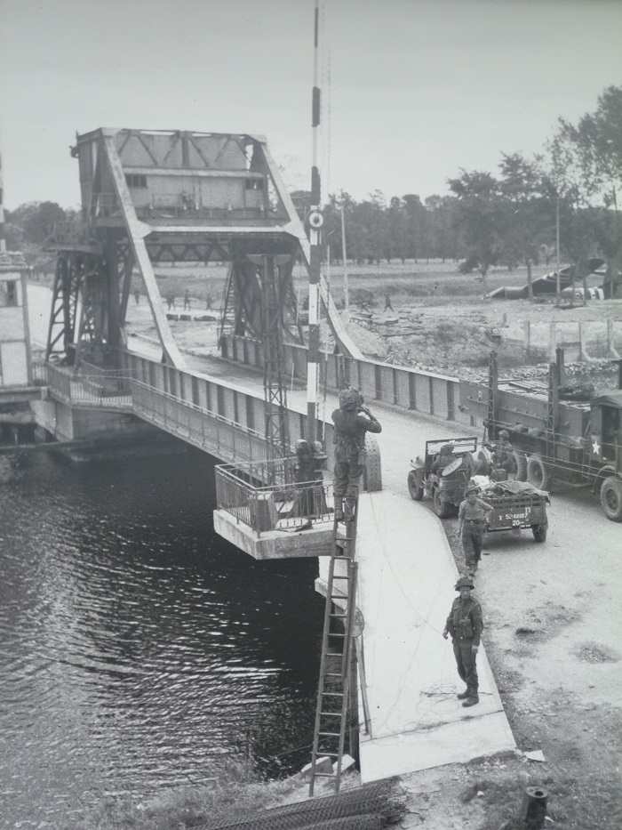 Black and white photo of Pegasus Bridge with crashed Horsa glider in background Normandy Landing Beaches