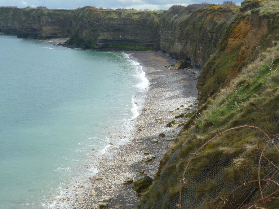 Looking down from La Pointe du Hoc on steep cliffs to the shore below. Part of the Normandy Landing Beaches