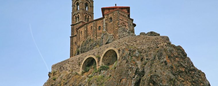 Looking up very high rocky pinacle in Le Puy to the Aiguille of St Michael Pilgrim Walking routes in France