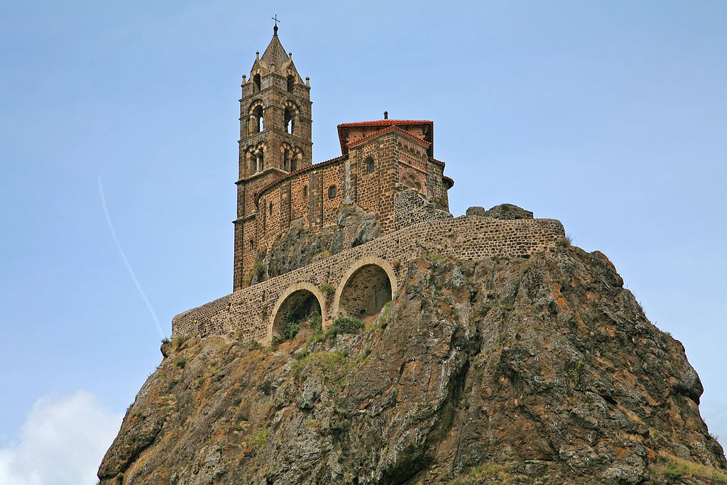 Looking up very high rocky pinacle in Le Puy to the Aiguille of St Michael Pilgrim Walking routes in France