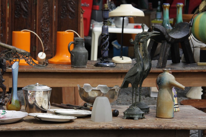 Rederie in Amiens with stall with shelves holding variety of antiques from old lamp to orange ceramic wellington boot, bird sculpture