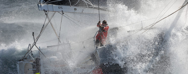 Boris Herrman in racing boat for Vendee Globe. Looking down through a p0lume of spray to the lone sailor