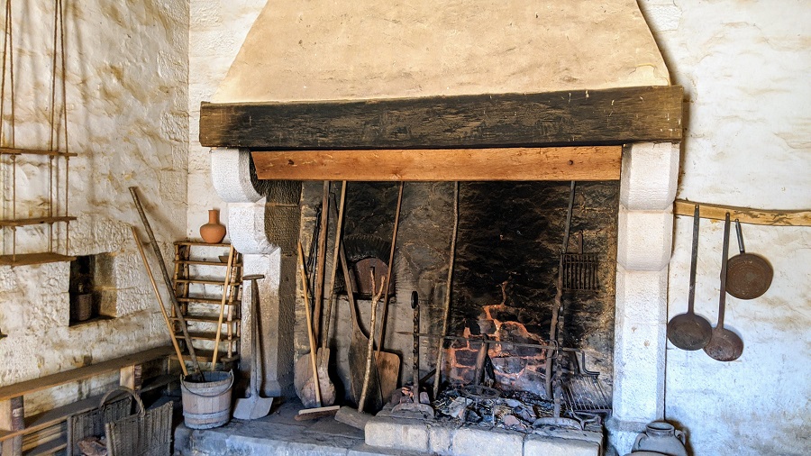 Huge kitchen fire range at Guedelon with iron pots, pans, ladles and implements