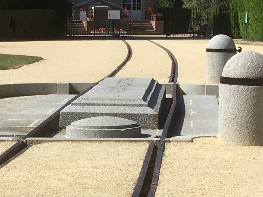 Rail tracks leading to central plaque let into ground at Armistice Museum. The place where the railway carriage stood for the signing of the Armistice in 1918