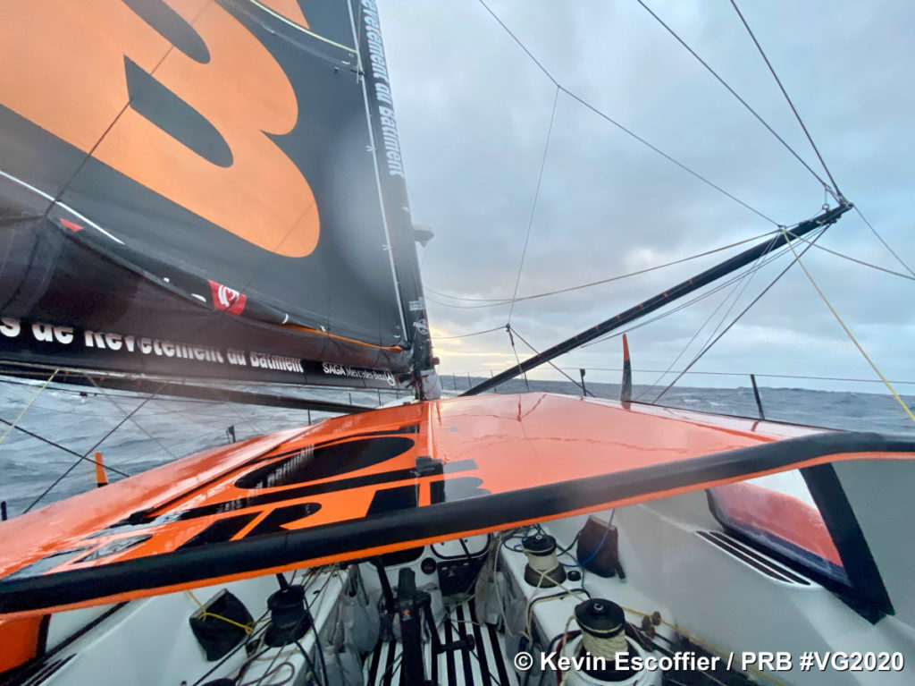 Kevin Escoffier in PRB Vendee Globe 2020 showing part of sail and front of boat slightly to one side