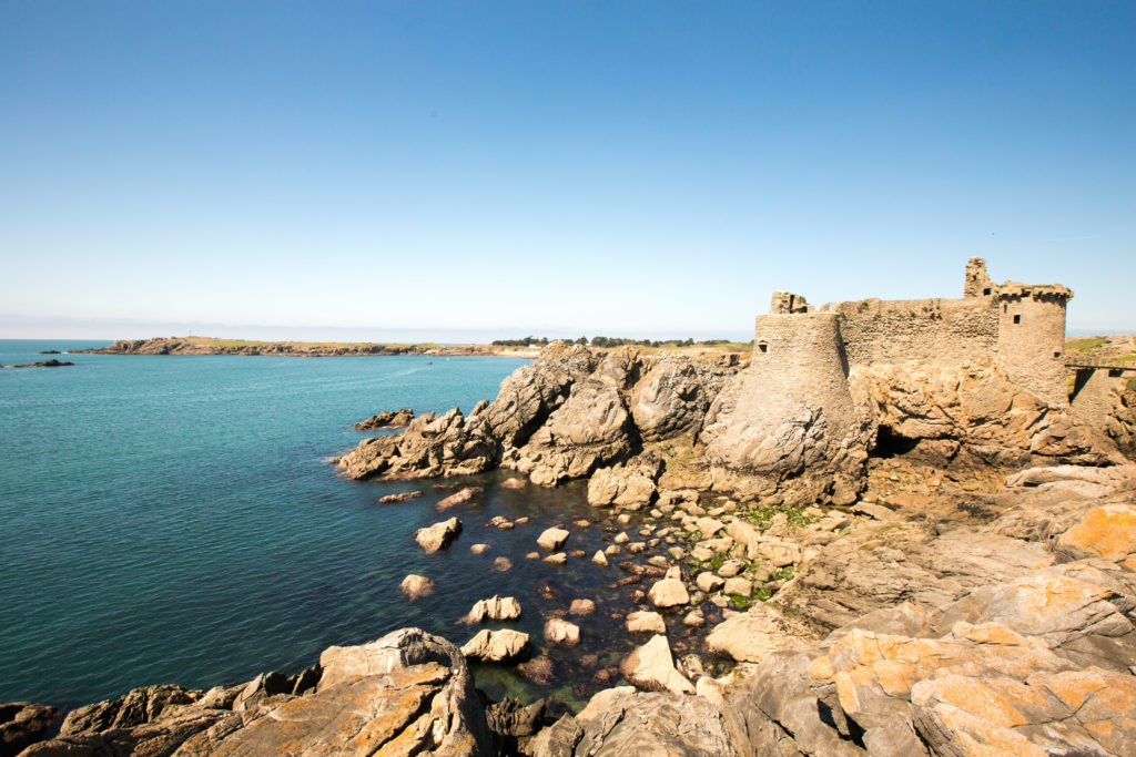 Ruined chateau on rocky, exposed headland on Ile d'Yeu with sea crashing on rocks below