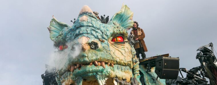 Calais Dragon facing camaera with steam coming out of nostrels and man on top manipulating him