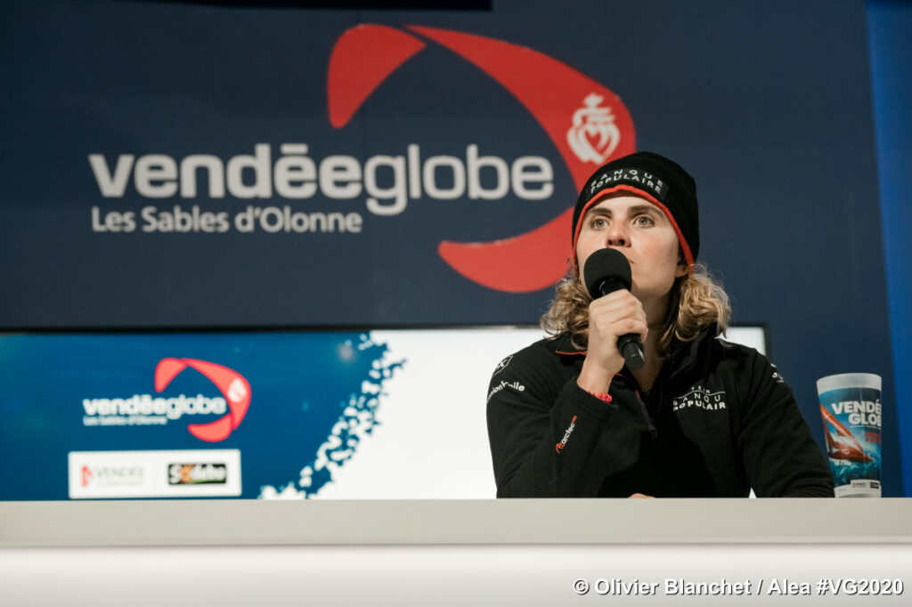 Clarisse Cremer with mic at press conference for Vendee Globe after she beat the women's world record held by Ellen McArthur