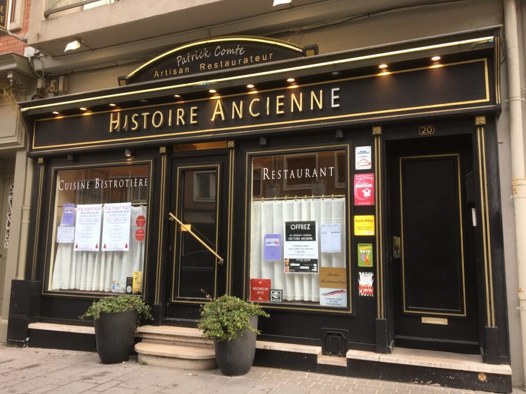 Outside Histoire Ancienne in Calais showing facade with name, chef's name, front door and windows in handsome colours
