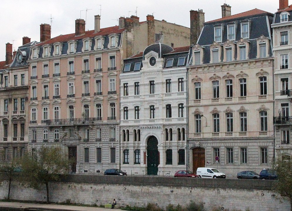 Synagogue in Lyon exterior on quai showing white building on quayside