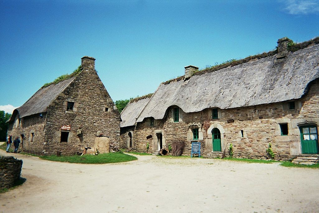 Longere, or long house in Morbihan, Brittany showing low one storey house with slate roof and windows under the eaves and another house facing it