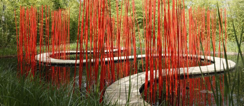 Chaumont-sur-Loire Gardens with installation by Yo Kongjian showing hanging red threads over large terracotta pots
