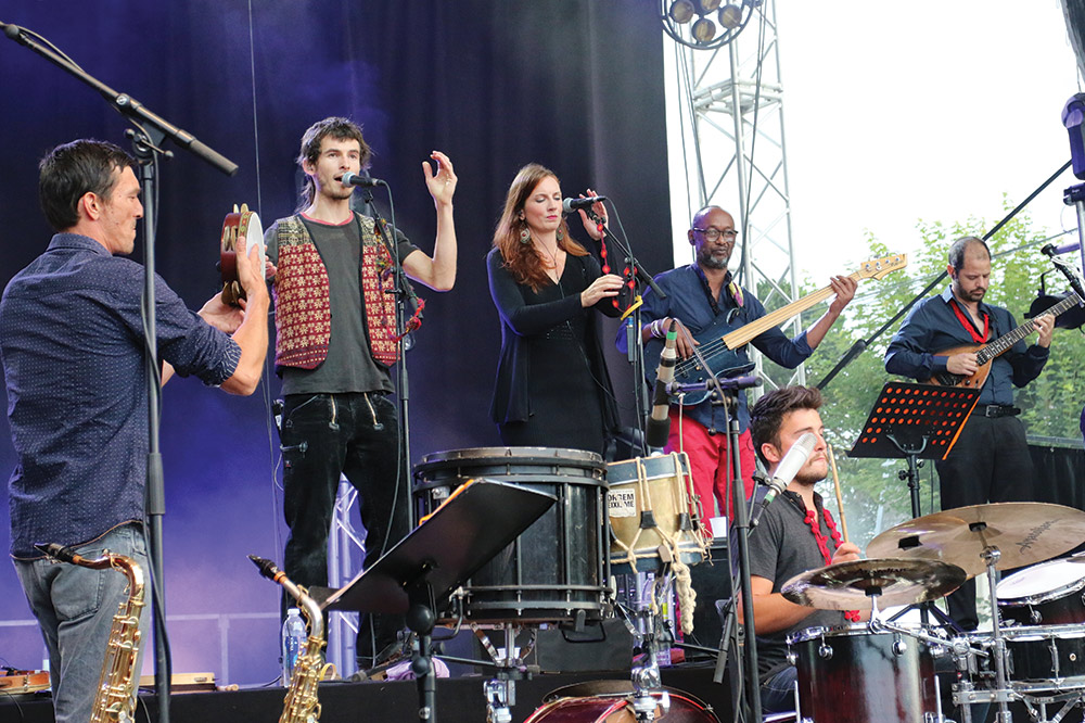 Festival de la Saint-Loup with band on stage, male and female singing and playing accoustic intruments