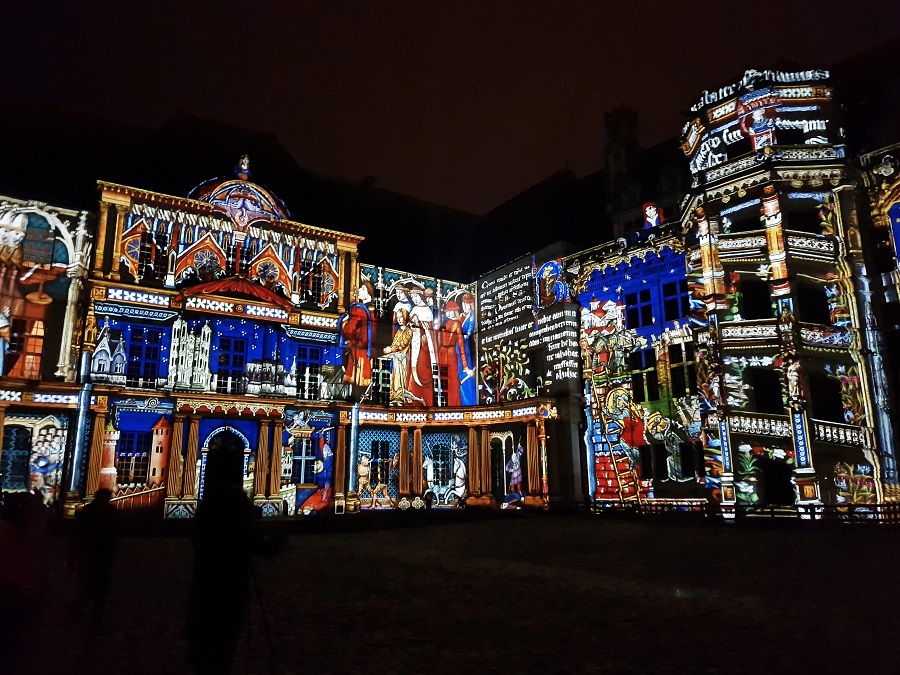 Blois chateau covered in light scenes with different colours as part of their nightly son et lumiere show