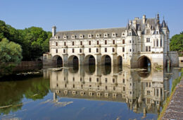 chenonceau chateau long white building reflected in waters of Cher river