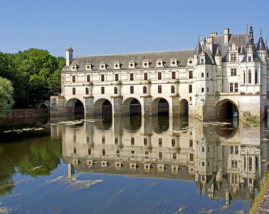 chenonceau chateau long white building reflected in waters of Cher river