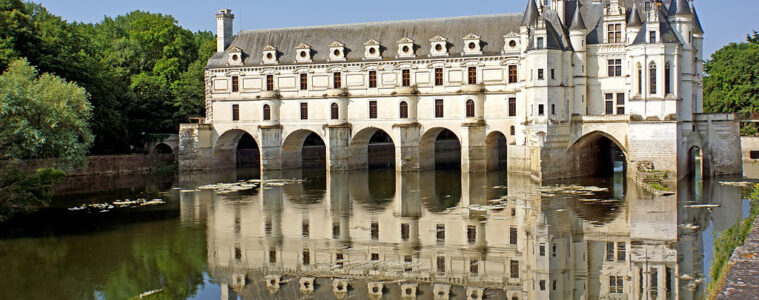 chenonceau chateau long white building reflected in waters of Cher river