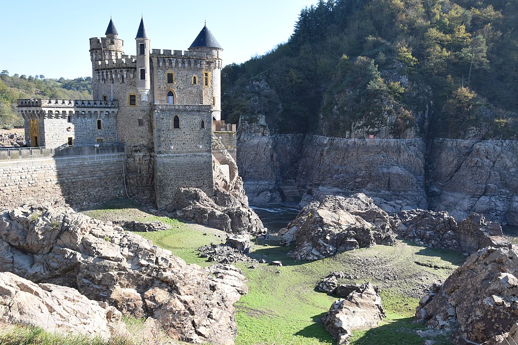 Château de La Roche Loire Valley showing medieval looking castle standing on rocks with more rocks on ground in front, huge high walls and hillside beyond